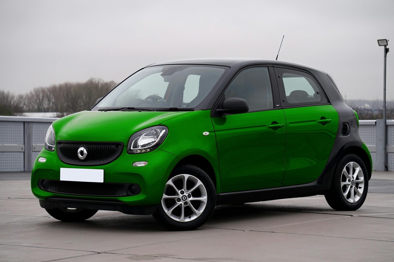 A green compact urban car parked outdoors, perfect for city driving. Modern and stylish design.